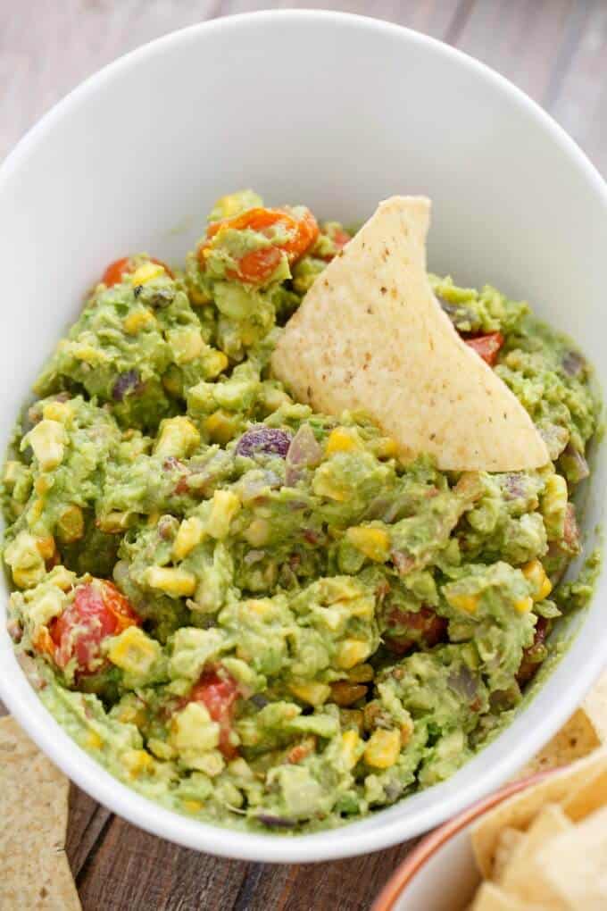 A bowl of food, with Guacamole and Bacon