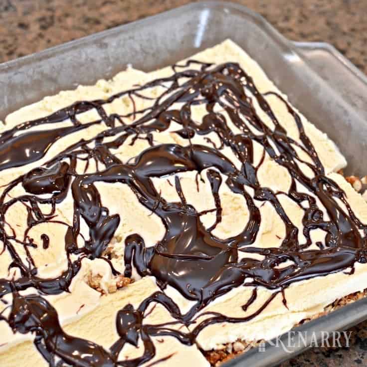 A close up of cake drizzled with chocolate sauce
