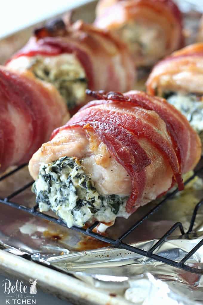 A close up of chicken wrapped in bacon and filled with spinach