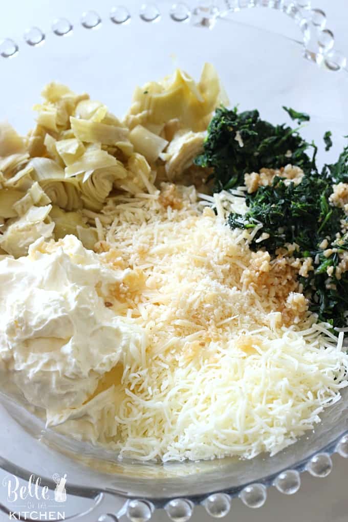 a bowl of filling for spinach and artichoke dip