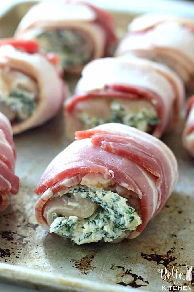 A close up chicken wrapped in bacon and filled with spinach