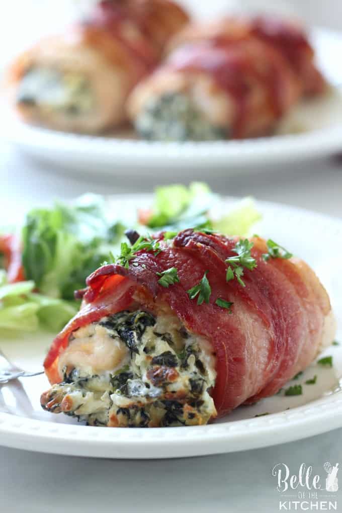 A close up chicken wrapped in bacon and filled with spinach