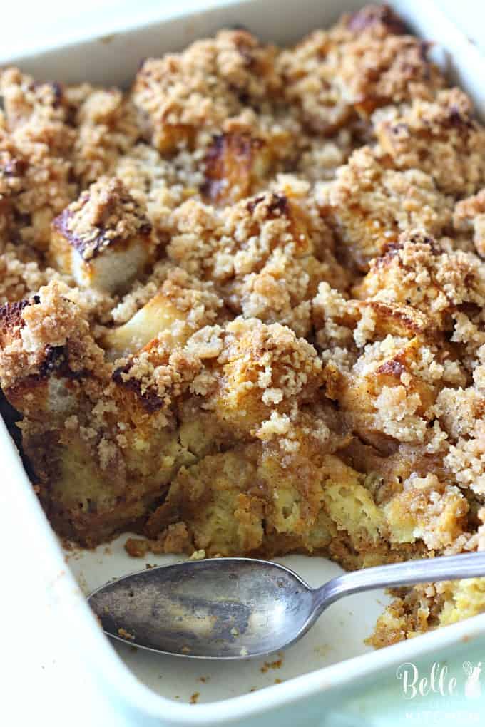 Caramel French Toast Casserole in a white dish with spoon and piece taken out