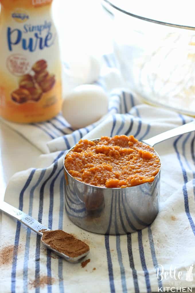 a measuring cup filled with pumpkin puree and an egg