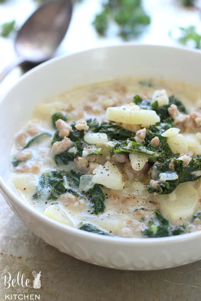 A bowl of soup with kale and potatoes 