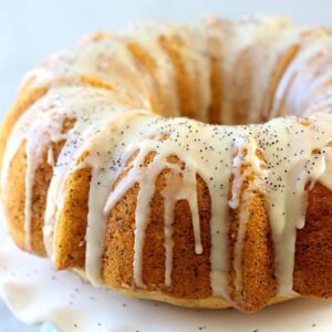 a lemon bundt cake with poppyseed vanilla glaze