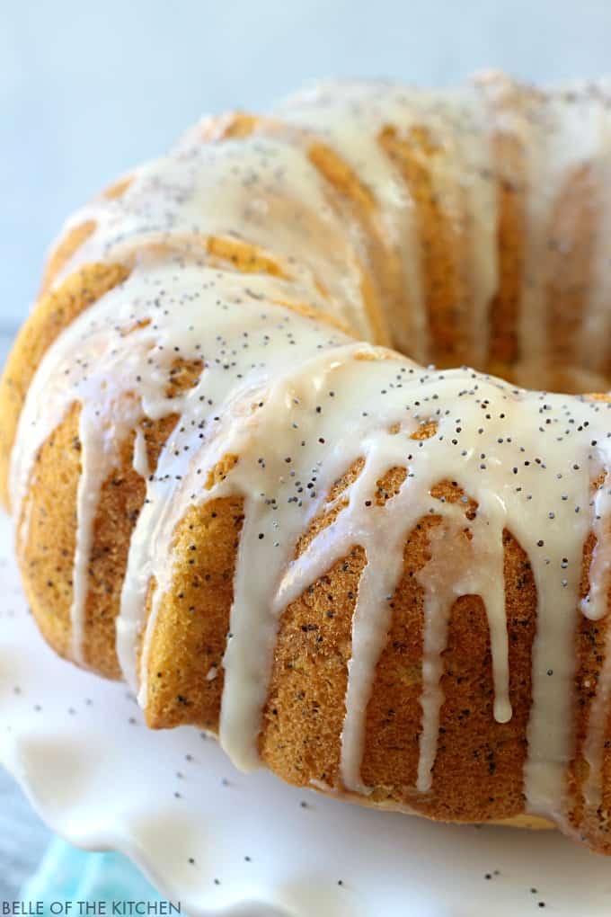 a lemon bundt cake with poppyseed vanilla glaze