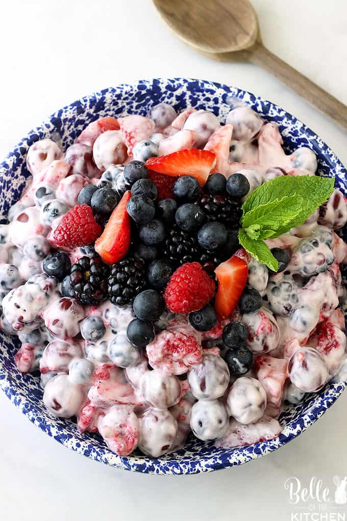 A bowl of fruit salad with mint and yogurt