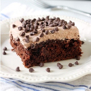 This Skinny Chocolate Cake is the ultimate guilt-free treat! It's made from a cake mix and protein packed greek yogurt, then topped with a light and fluffy whipped frosting! Each serving clocks in at just under 200 calories!