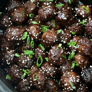 Crockpot Honey Sriracha Meatballs - yummy meatballs cooked in the crockpot in a tangy sauce with a kick of Sriracha. These make for an easy appetizer or a main dish served over rice!