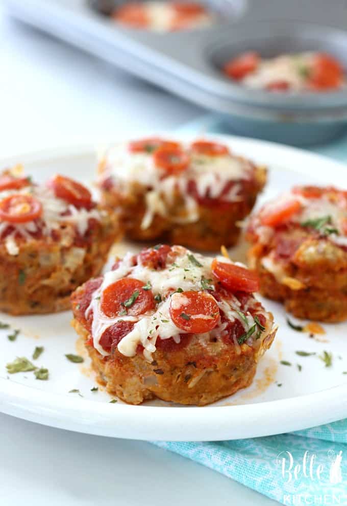 A plate of mini meatloaves with pepperoni on a white plate