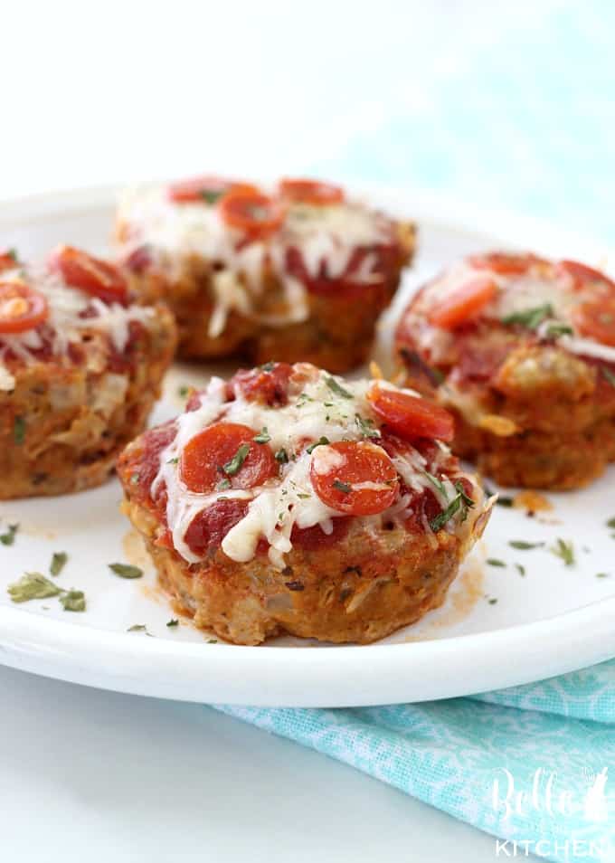 A plate with individual meatloaf cups topped with pepperoni