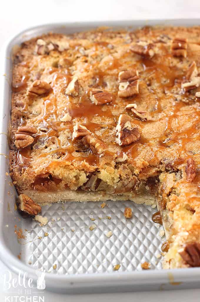 A tray of pecan pie bars with a slice taken out