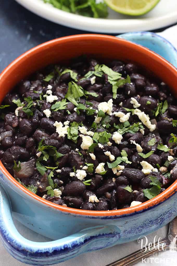 A bowl filled with black beans and cotija
