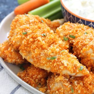 These Baked Buffalo Chicken Fingers are perfect for an easy, tasty dinner, or an appetizer for a crowd. They're quick, crispy, and taste delicious dipped into bleu cheese with chopped celery and carrots on the side!