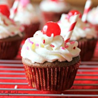 These Cherry Coke Float Cupcakes are so moist and delicious. They are stuffed with cherries then topped with a delicious whipped cream frosting!
