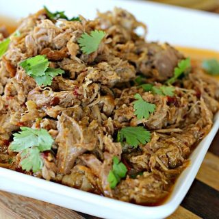 Slow Cooker Pork Carnitas - Flavorful, juicy pork that cooks all day in your crockpot. Serve over corn tortillas with with all of your favorite topping for a delicious, easy dinner.