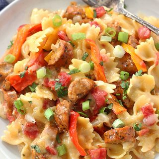 This Cheesy Sausage and Peppers Pasta is made in one pot and is one of our dinner time favorites. It's so easy to make and is perfect for busy weeknights!