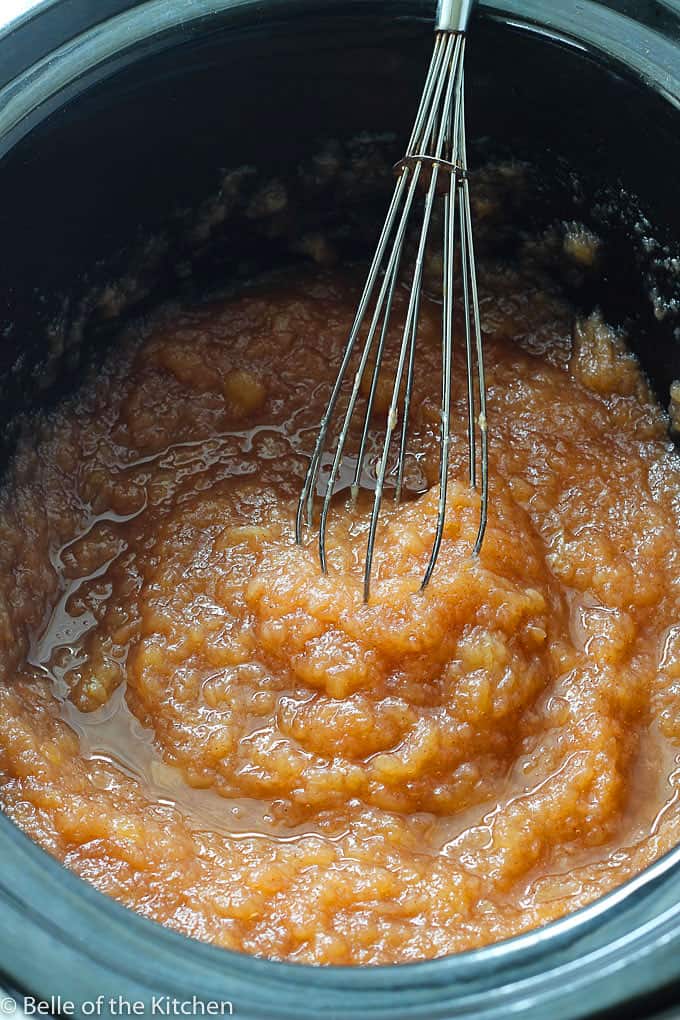 A bowl of applesauce being whisked 