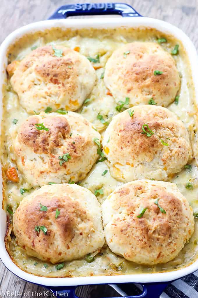 a dish of chicken casserole with biscuits on top