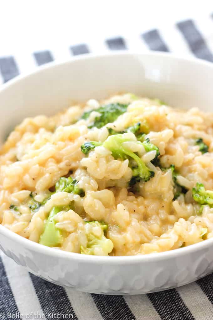 A bowl of food with rice and broccoli, with Cheese