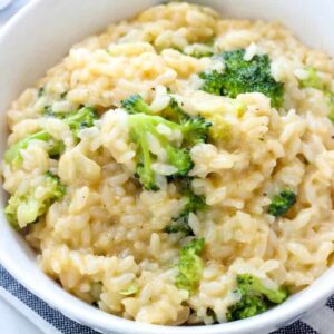 A bowl of food with rice and broccoli