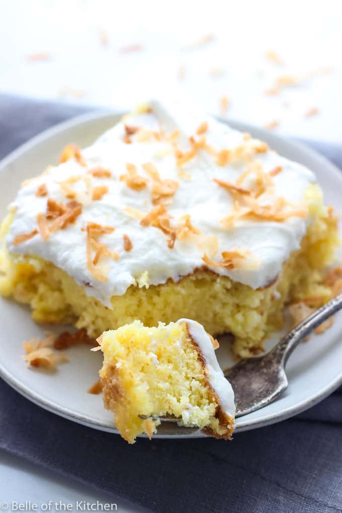 A plate of Piña colada cake with a bite taken out