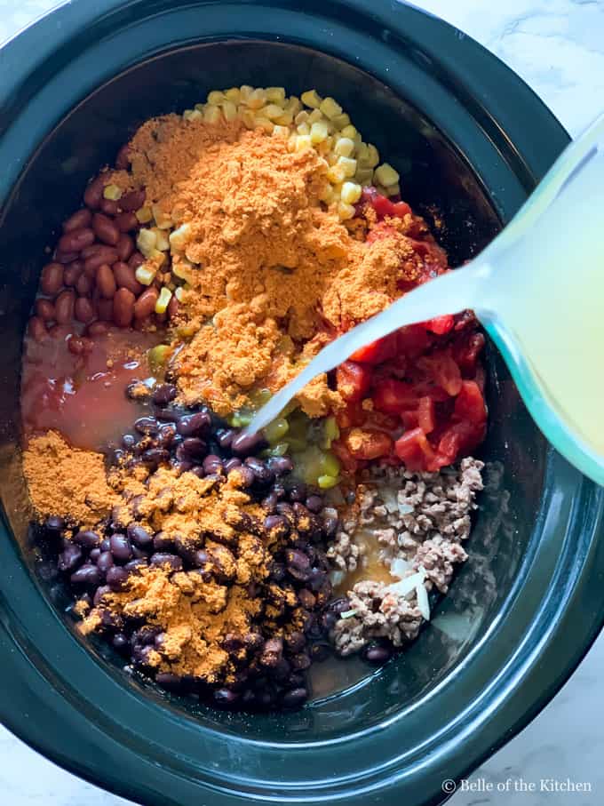 taco soup being made in a slow cooker
