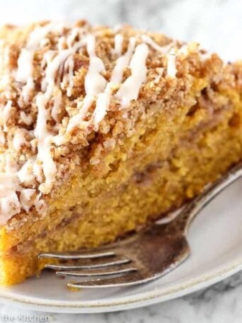 A piece of Pumpkin Coffee cake on a plate with a fork