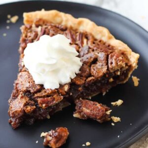 A piece of Chocolate Pecan pie on a plate