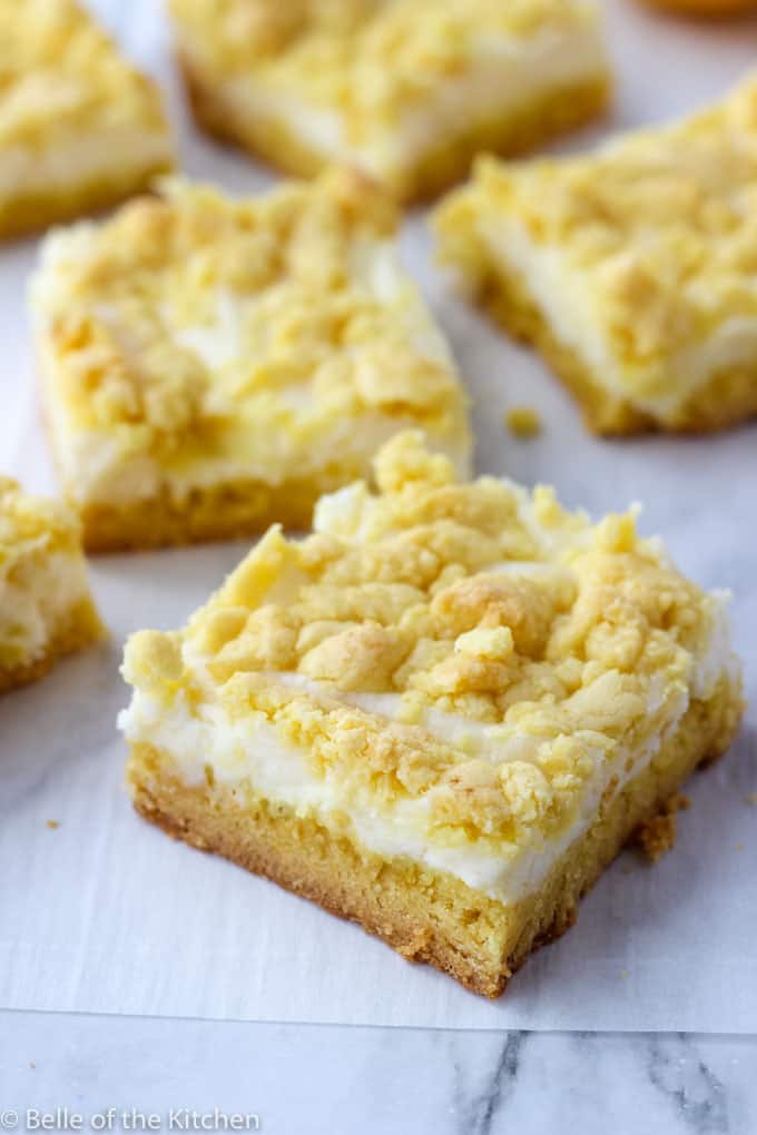white background with sliced lemon cheesecake bars