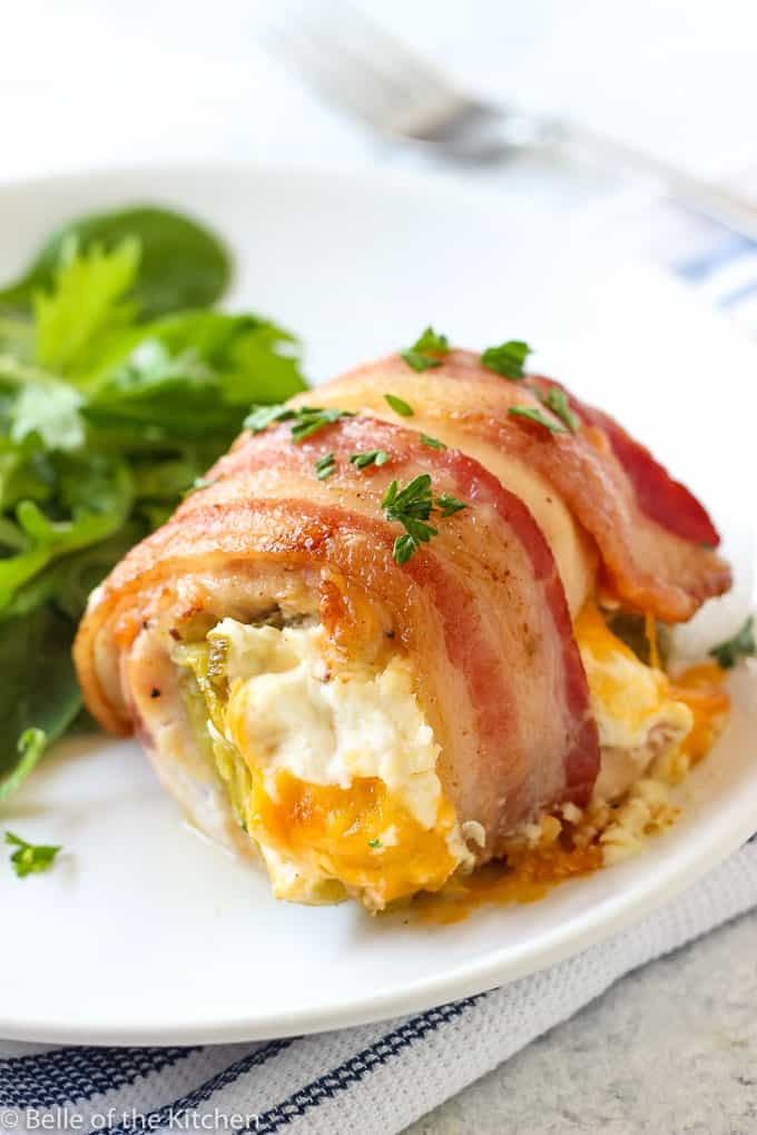 a plate with salad and chicken wrapped in bacon