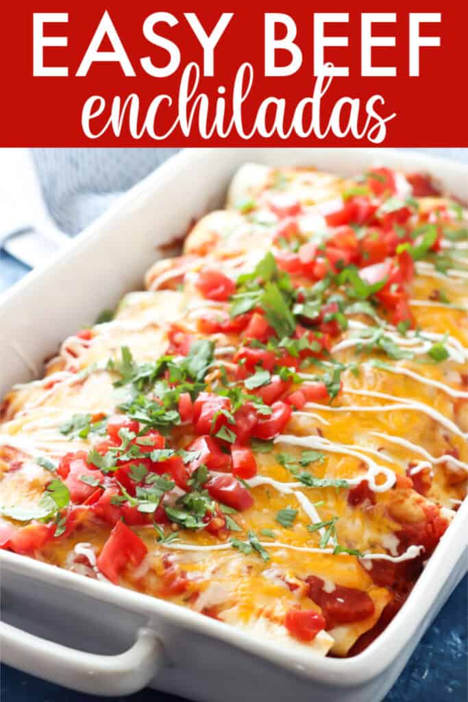 white rectangle casserole dish with enchiladas, diced tomatoes, cilantro, and sour cream