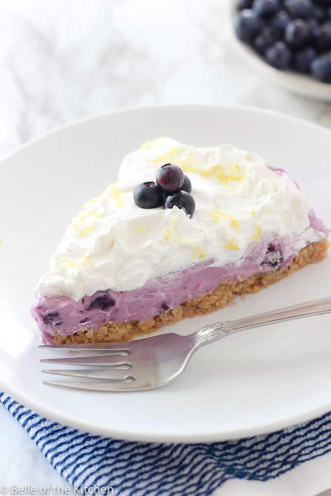 slice of blueberry cream pie on a plate with a fork