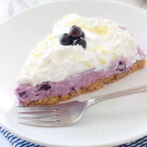 slice of blueberry cream pie on a plate with a fork