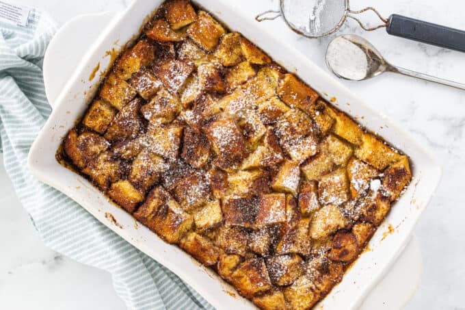 a white baking dish full of french toast casserole
