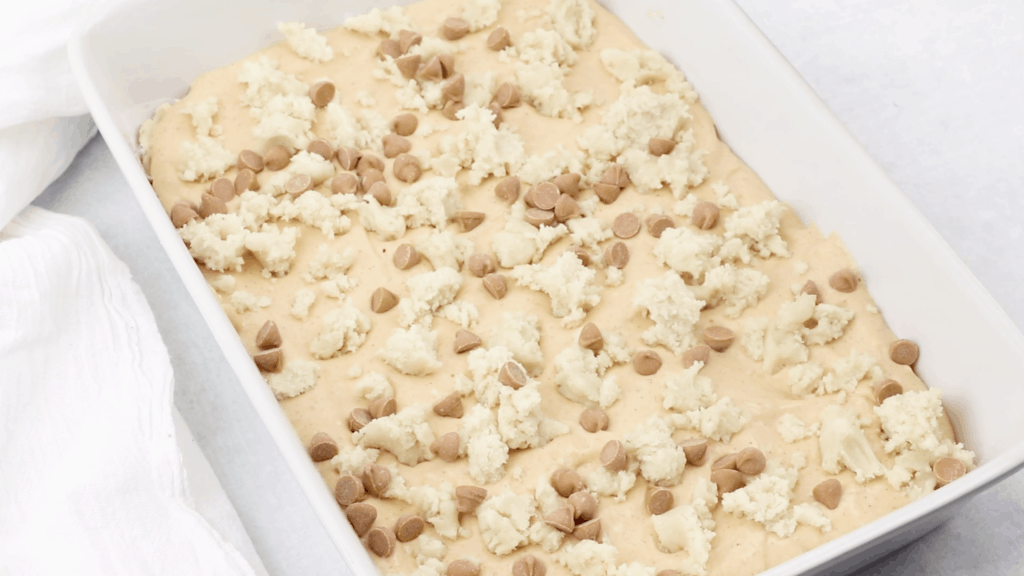 a baking dish full of cookie dough and sprinkled with cinnamon chips