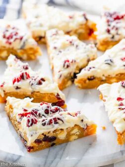 a marble tray full of cranberry bliss bars cut in triangles