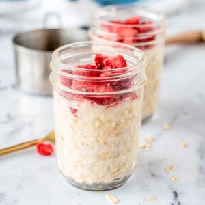 a mason jar full oatmeal and strawberries