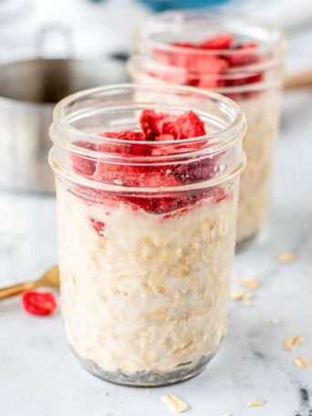 a mason jar full oatmeal and strawberries