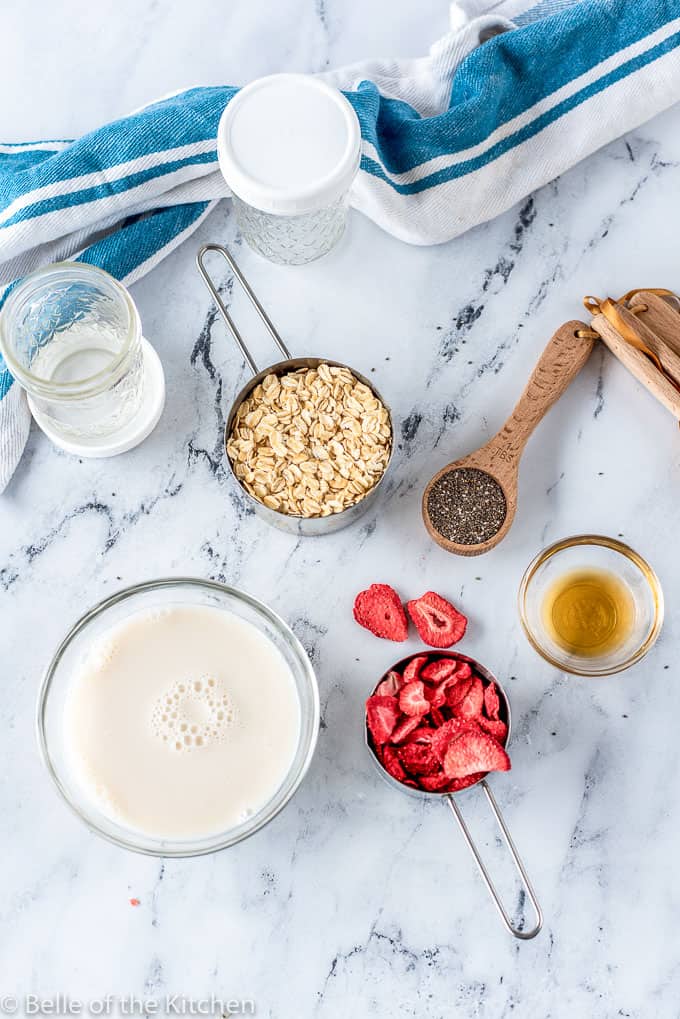 ingredients laid out on a marble background for overnight oats