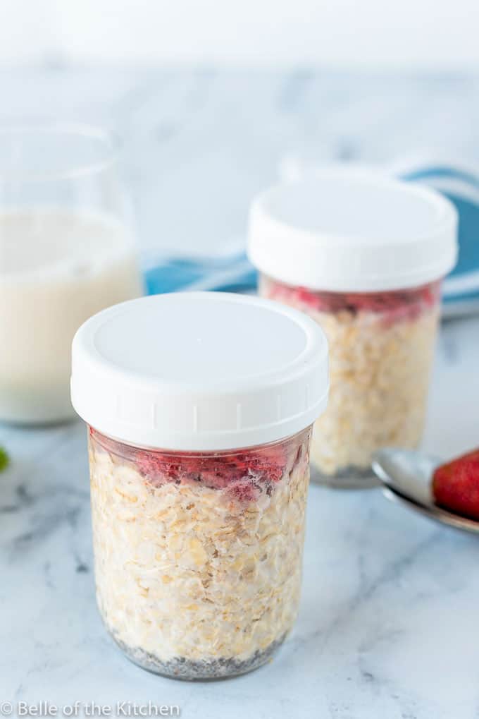 mason jars full of oatmeal and strawberries