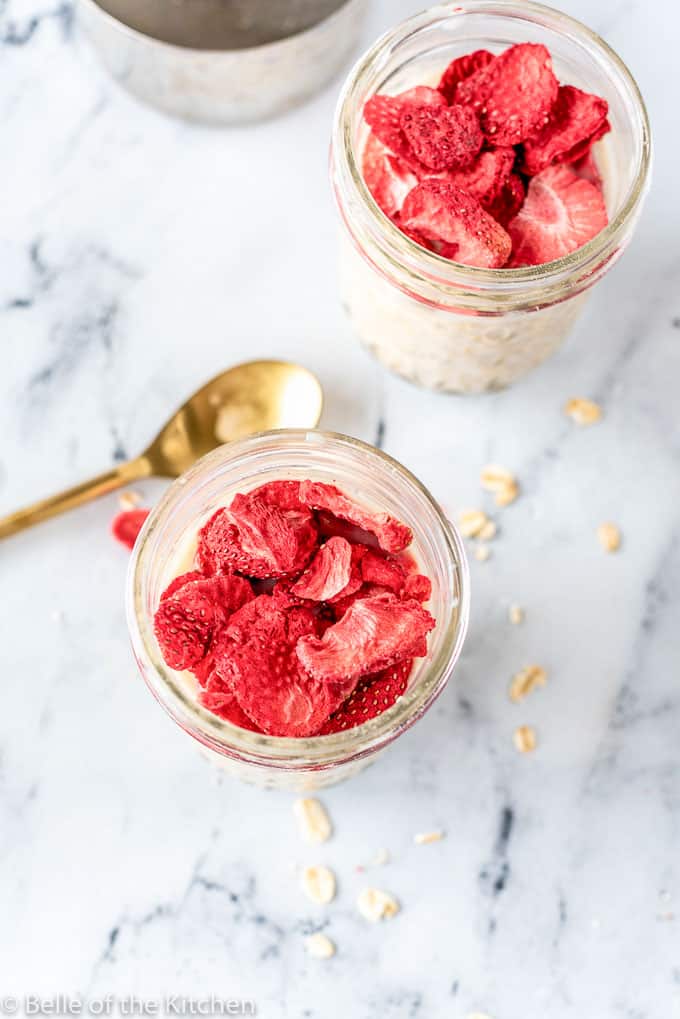 mason jars full of overnight oats and strawberries