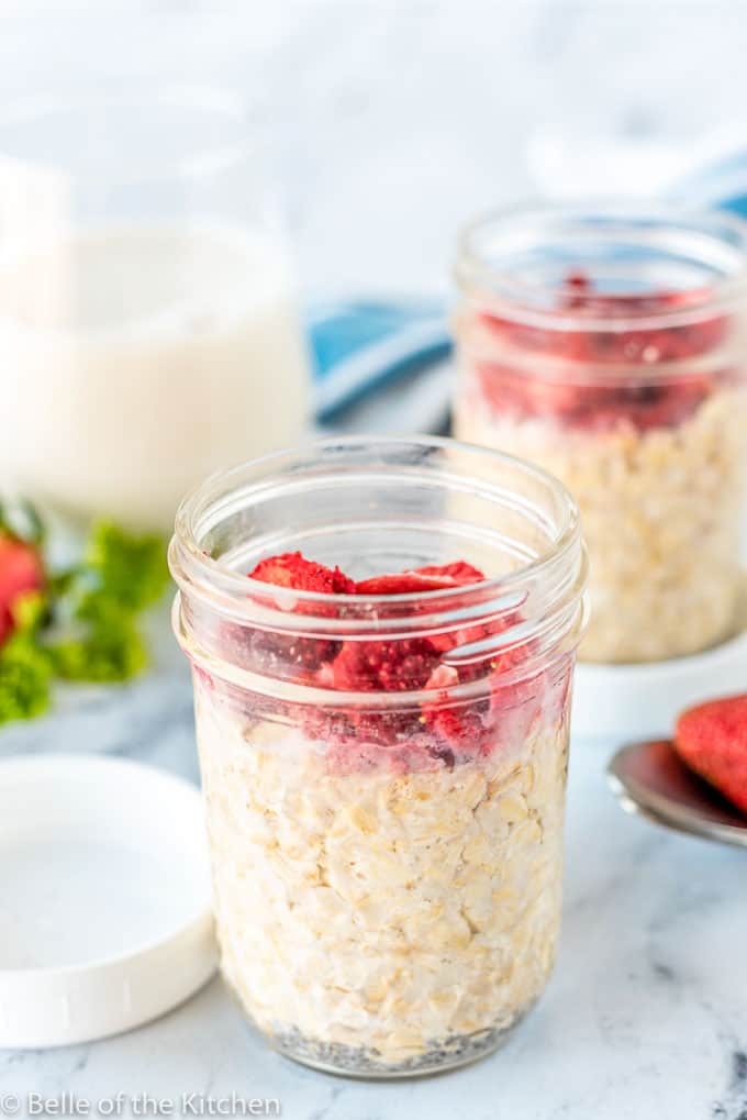 mason jars full of overnight oats and strawberries