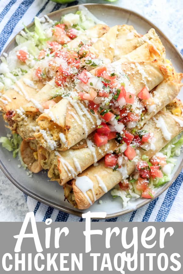 taquitos on a plate topped with pico, cheese, and lettuce
