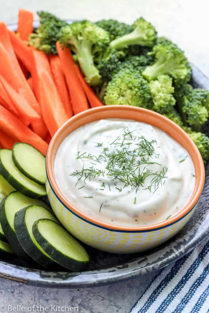 greek yogurt ranch dip in a bowl with veggies around it