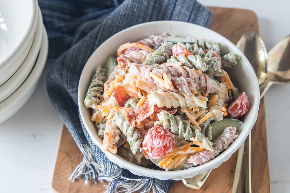 a bowl of pasta salad on a blue napkin