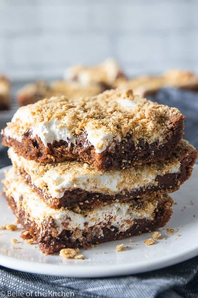 a stack of s'mores bars with a bite taken out of the one on top