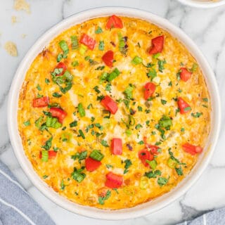 corn dip topped with tomatoes, green onions, and cilantro