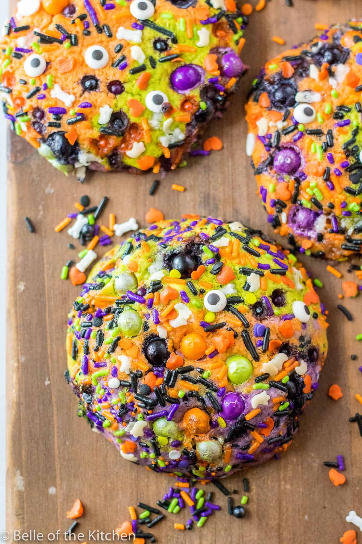 Halloween sugar cookies with sprinkles on a cutting board